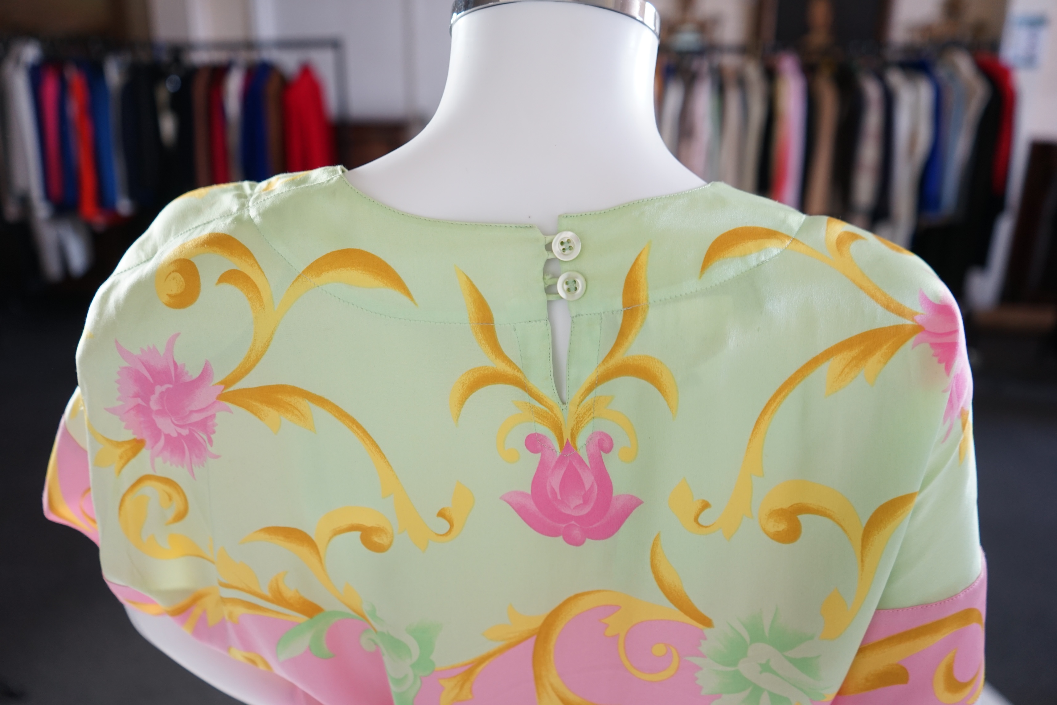 A pink Escada suit with a silk blouse top. Proceeds to Happy Paws Puppy Rescue